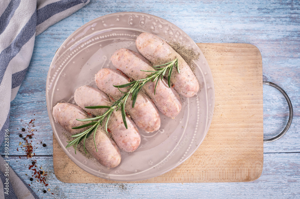 Traditional steamed white sausage on a plate, on a wooden background. Composition with white sausage, easter delicacy. Traditional steamed white sausage on a plate, on a wooden background. Composition with white sausage, easter delicacy.