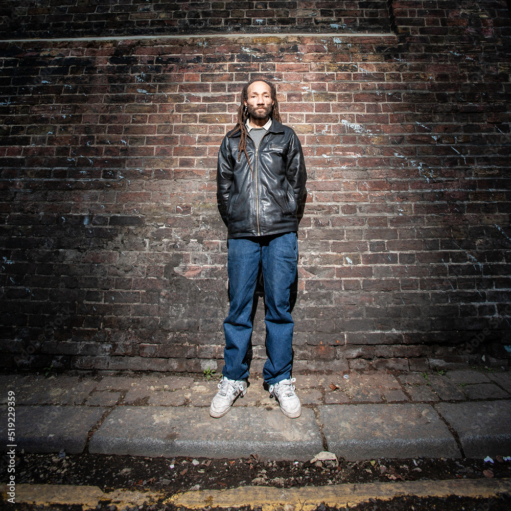 Street Life Portrait. Full body portrait of a homeless character in a London back street. From a series with the same model.