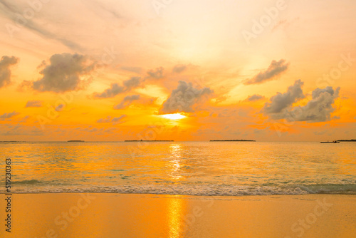 picturesque sunrise in the Maldives island  the sun rising from the Indian ocean and reflected in the water  travel concept