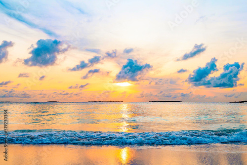 picturesque sunrise in the Maldives island, the sun rising from the Indian ocean and reflected in the water, travel concept © klavdiyav