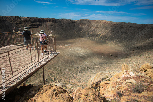 A Family looking at the Barringer Meteor Crater from the Observation Deck photo