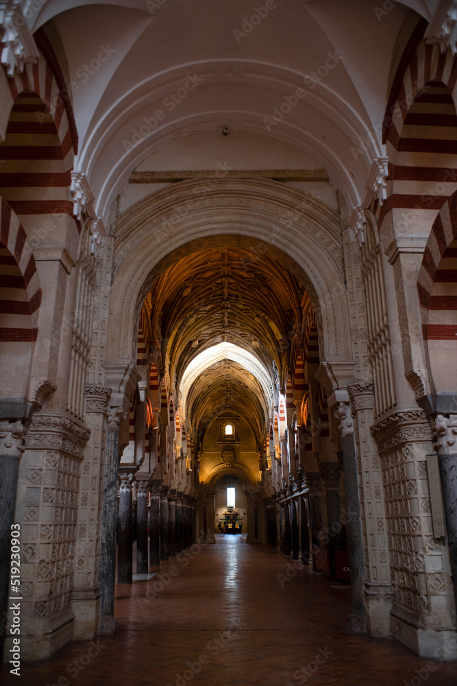 CÓRDOBA, SPAIN - APRIL, 2016. Arches Pillars Mezquita Cordoba Spain. Created in 785 as a Mosque, was converted to a Cathedral in the 1500. 850 Columns and Arches. Painted and striped arches.
