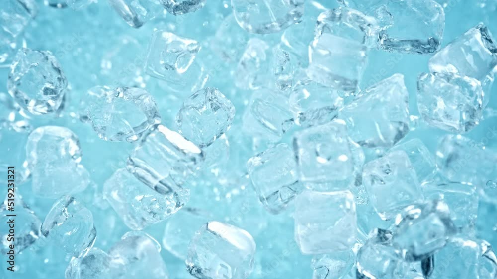 Super Slow Motion Shot of Ice Cubes Explosion Towards Camera on Light Blue Background at 1000 fps. Super Slow Motion Shot of Ice Cubes Explosion Towards Camera on Light Blue Background at 1000 fps.