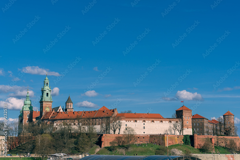 Wawel Royal Castle in Krakow on a sunny day under a cloudy sky, Poland, cityscape, tourist attractions, historic site