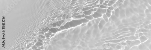 Water texture with wave sun reflections on the water overlay effect for photo or mockup. Organic light gray drop shadow caustic effect with wave refraction of light. Long Banner with copy space.