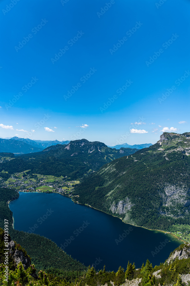 Stunning aerial view of Altaussee lake from Trisselwand with the peak Standling and Loser on a sunny summer day, Salzkammergut-Ausseerland region, Styria, Austria