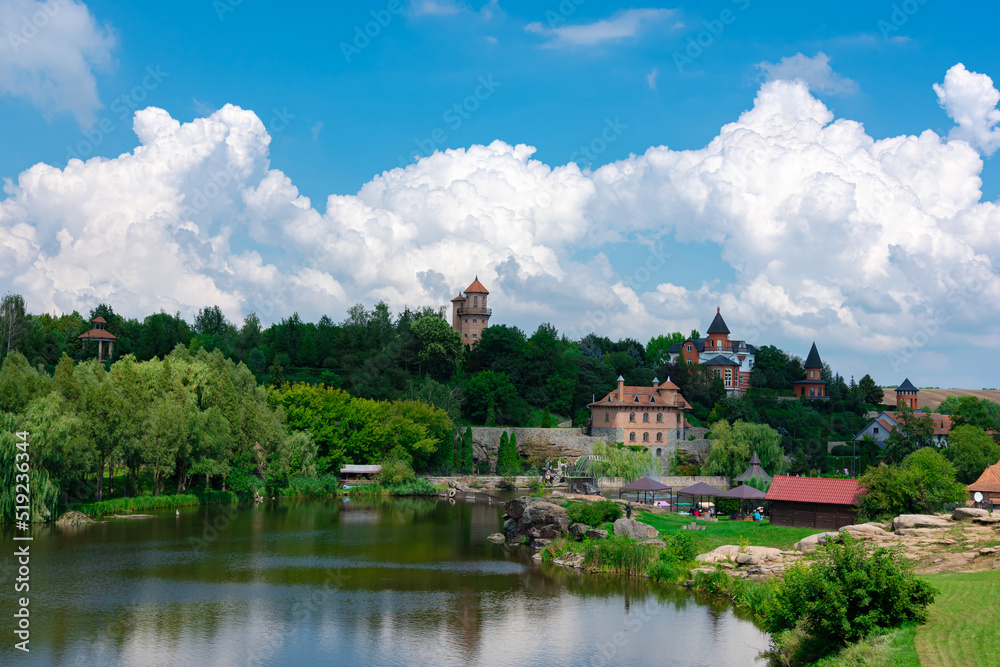 beautiful view of the lake and the castle in Buky Landscape Park, Ukraine. Blue sky with beautiful clouds