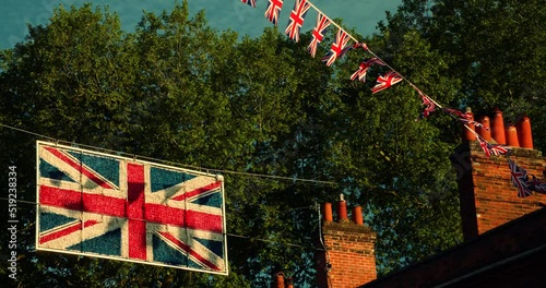 Union Jack flags flying from houses in the streets of Britain, vintage LUT
