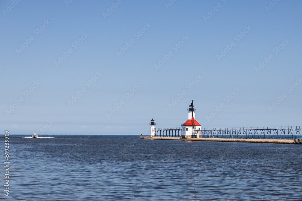 Boat in the lake and St. Joseph North Pier Inner Lighthouse and St. Joseph North Pierhead Outer Lighthouse, Michigan Boat in the lake and St. Joseph North Pier Inner Lighthouse and St. Joseph North Pierhead Outer Lighthouse, Michigan