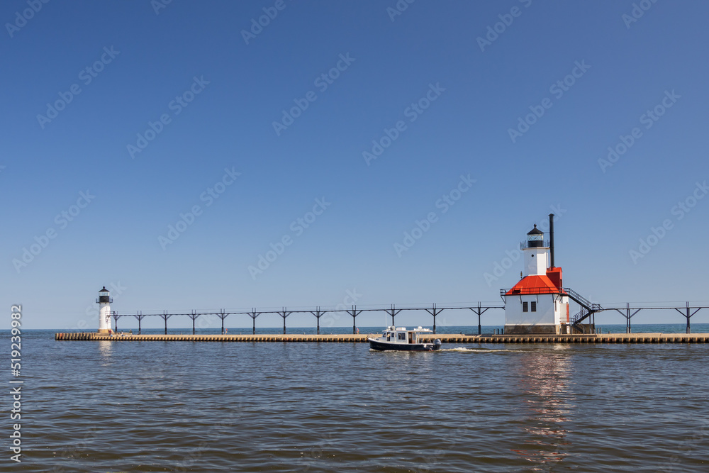 Boat in the channel and St. Joseph North Pier Inner Lighthouse and St. Joseph North Pierhead Outer Lighthouse, Michigan 