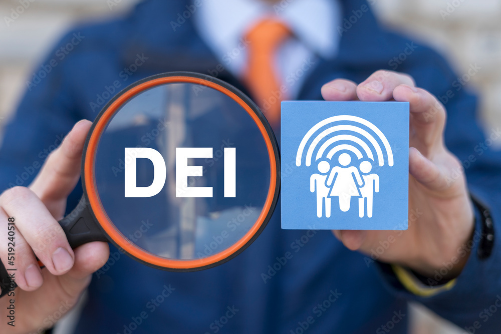 DEI Diversity Equality Inclusion Belonging Human Rights concept. Man holding magnifying glass with abbreviation of DEI and polystyrene foam block with diversity people group and rainbow sign. DEI Diversity Equality Inclusion Belonging Human Rights concept. Man holding magnifying glass with abbreviation of DEI and polystyrene foam block with diversity people group and rainbow sign.