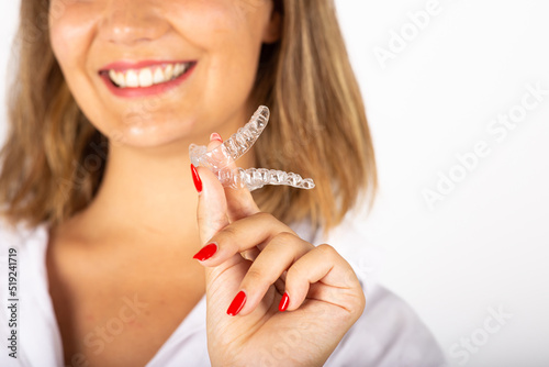 Beautiful smiling young woman with aligner.