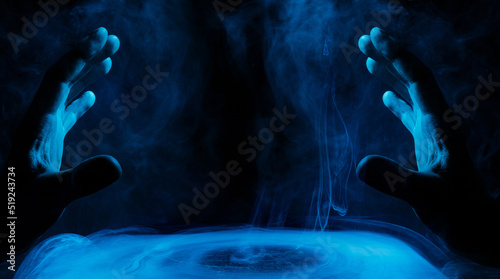 Crystal sphere with mystical smoke in hands. Mysterious composition. Fortune teller, mind power, prediction, halloween concept. Wide angle horizontal wallpaper or web banner. Mockup for your logo.