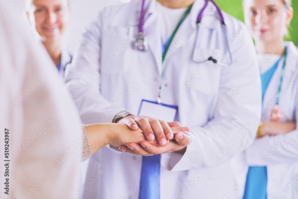 Doctors and nurses in a medical team stacking hands Doctors and nurses in a medical team stacking hands