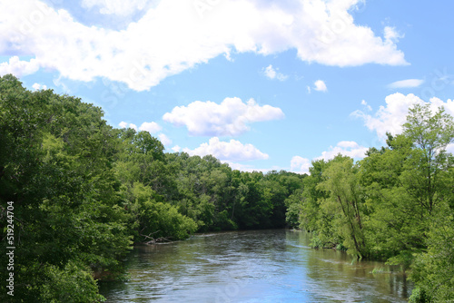 river water tree lined waterway clouds blue sky tranquil riparian countryside rural landscape