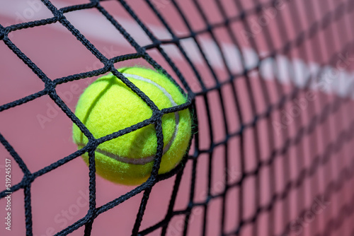 CLOSEUP OF A TENNIS OR PADEL BALL HITTING THE NET. © Rafa Jodar