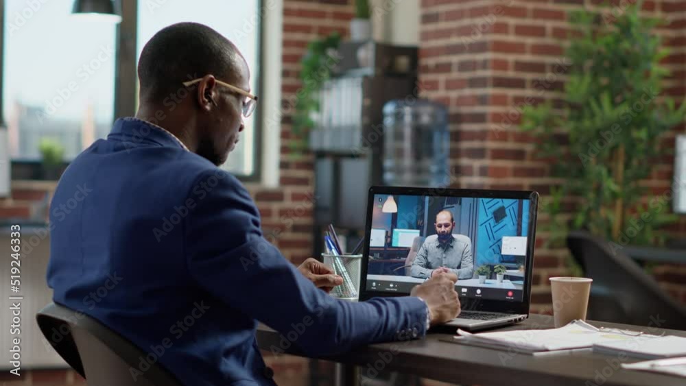 Company employee attending remote videocall meeting with man on laptop, having conversation on webcam. Talking to manager on online teleconference call, internet telework communication. Company employee attending remote videocall meeting with man on laptop, having conversation on webcam. Talking to manager on online teleconference call, internet telework communication.