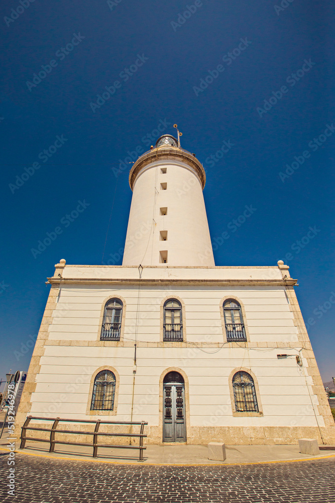 La Farola - Malaga lighthouse at sunset, Andalusia, Spain La Farola - Malaga lighthouse at sunset, Andalusia, Spain