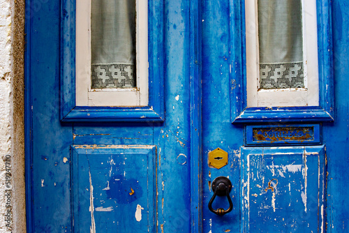 Beautiful old wooden blue door in traditional Lisbon house, Portugal