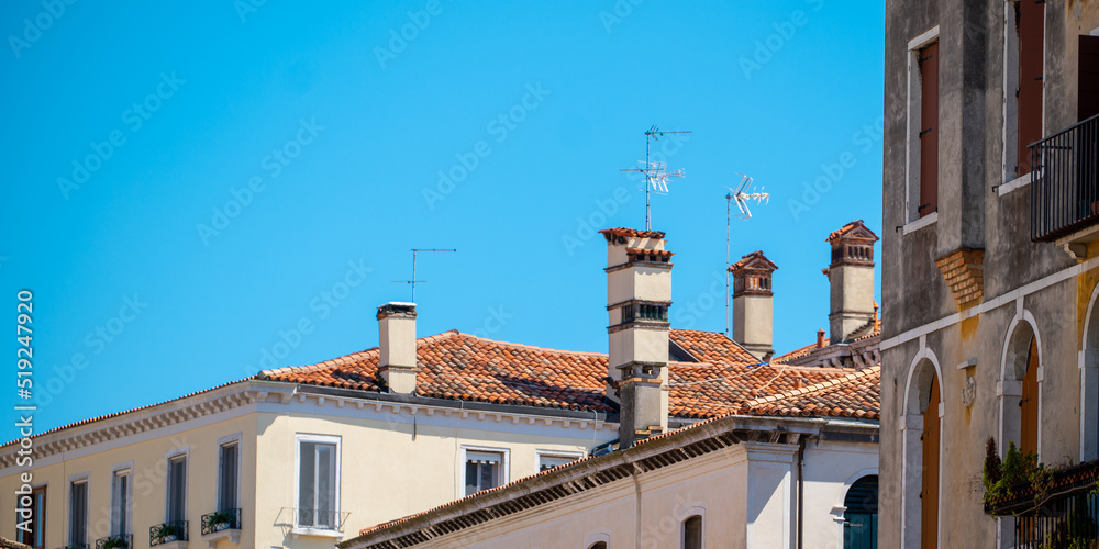 Architecturally beautiful Venetian roofs set against a turquoise blue sky.