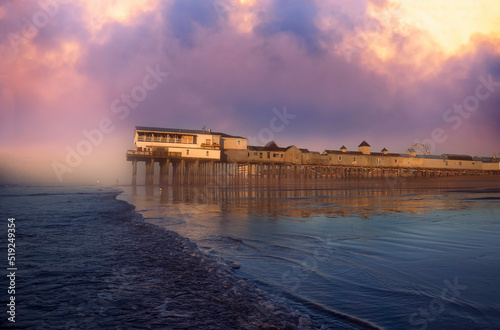 Pier in fog at dawn. A famous place on the coast of the Atlantic Ocean. Old pier. USA. Maine. Old Orchard Beach. 