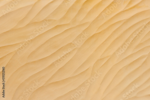 Texture of yellow sand. Natural background © leeyiutung