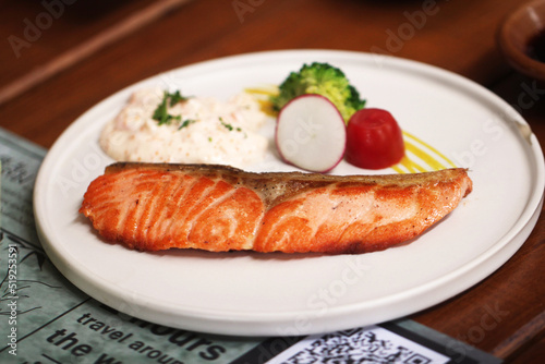 plate of grilled salmon steak with vegetables