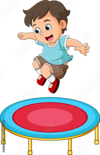 The cute boy is jumping on the trampoline with the happy expression