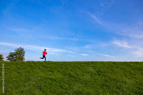 Young Asian girls jogging for fitness in the open grass