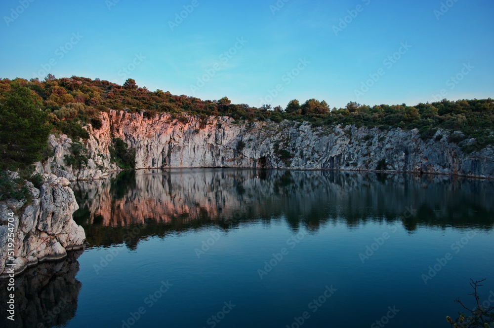 Rock formation reflected in water of lake
