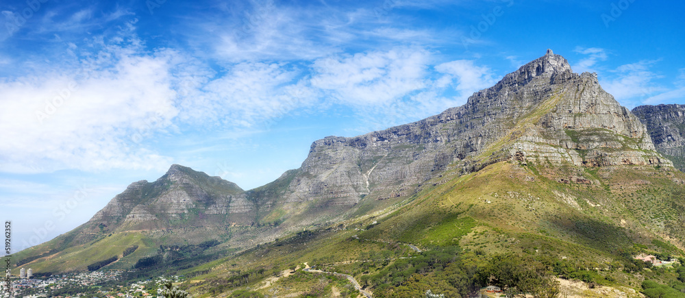 Panoramic view of Table Mountain against a cloudy blue sky with copyspace. Vibrant, beautiful landscape of nature. A popular location in Cape Town for travel, hiking and adventure