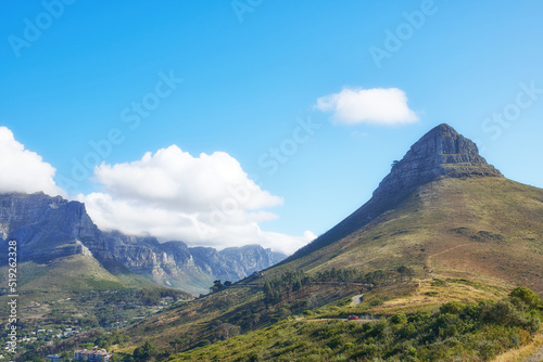 View of mountains with a path and cityscape against blue sky copyspace. A peaceful mountain with a scenic background in quiet Lions Head in Cape Town, South Africa. Nature backdrop with a hill top