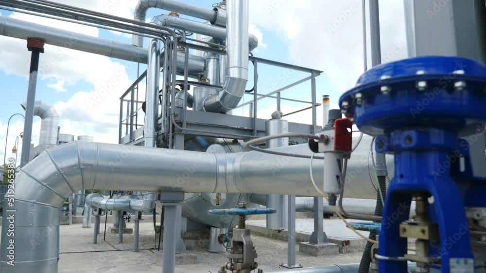 Chemical plant pipelines. Heavy industry. Large industrial tubing and piping inside central heating plant. Steam heat exchangers. Degassing channels. Interior industrial gas boiler with piping, pumps Chemical plant pipelines. Heavy industry. Large industrial tubing and piping inside central heating plant. Steam heat exchangers. Degassing channels. Interior industrial gas boiler with piping, pumps