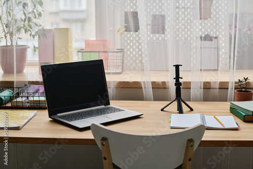 Horizontal image of workplace with laptop for online studying in teenage room © AnnaStills