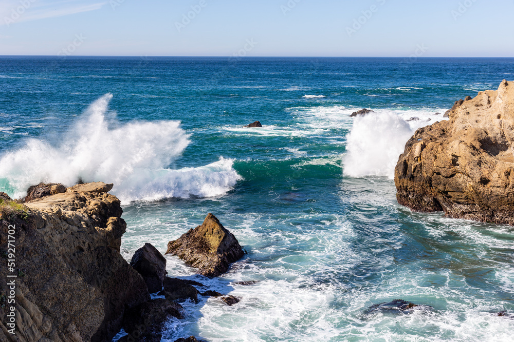 A view on Pacific ocean coast with blue sky and water and waves A view on Pacific ocean coast with blue sky and water and waves