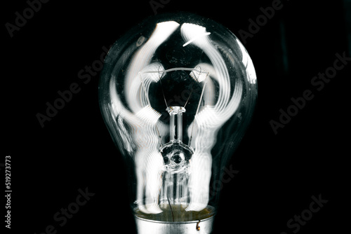 Glass light bulb close up on black background photo