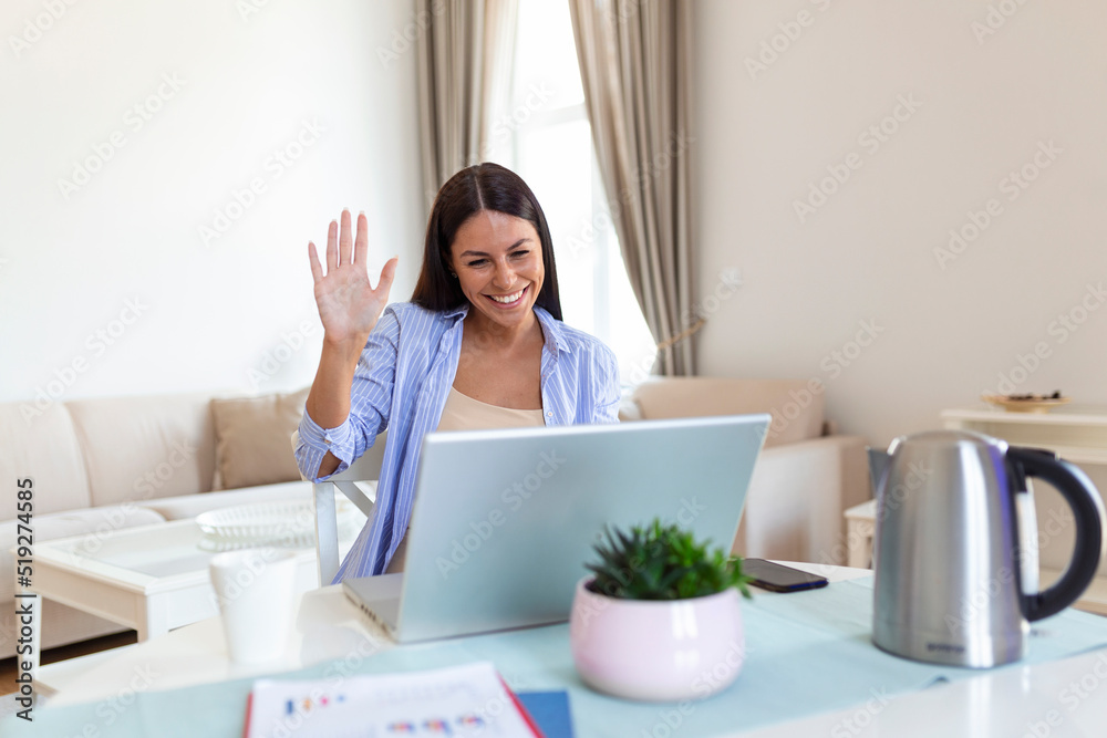 Young woman waving at laptop and talking to her friends via video call, girl student talking by video conference call, female teacher trainer tutoring by webcam, online training, e-coaching concept Young woman waving at laptop and talking to her friends via video call, girl student talking by video conference call, female teacher trainer tutoring by webcam, online training, e-coaching concept