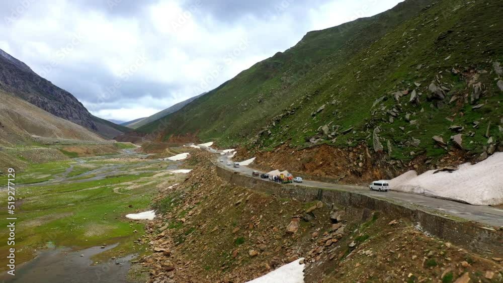Drone shot of the Babusar Pass mountain pass in Pakistan, with a few vehicles on the road in the Kaghan Valley Drone shot of the Babusar Pass mountain pass in Pakistan, with a few vehicles on the road in the Kaghan Valley