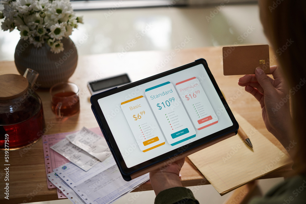 © DragonImages - Closeup image of female customer paying for service subscription with credit card © DragonImages - Closeup image of female customer paying for service subscription with credit card