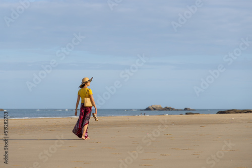 Woman walk on the beach photo