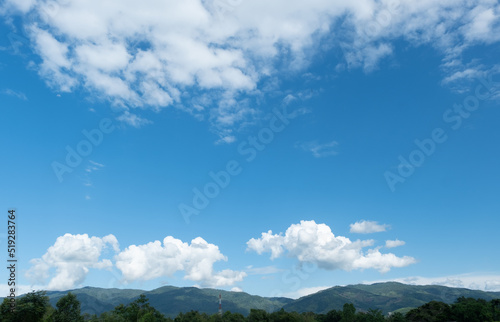 The white clouds have a strange shape and moutain.The sky and the open space have mountains below.