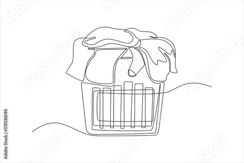 Continuous one line drawing Pile of dirty laundry in a washing basket. Laundry service concept. Single line draw design vector graphic illustration.