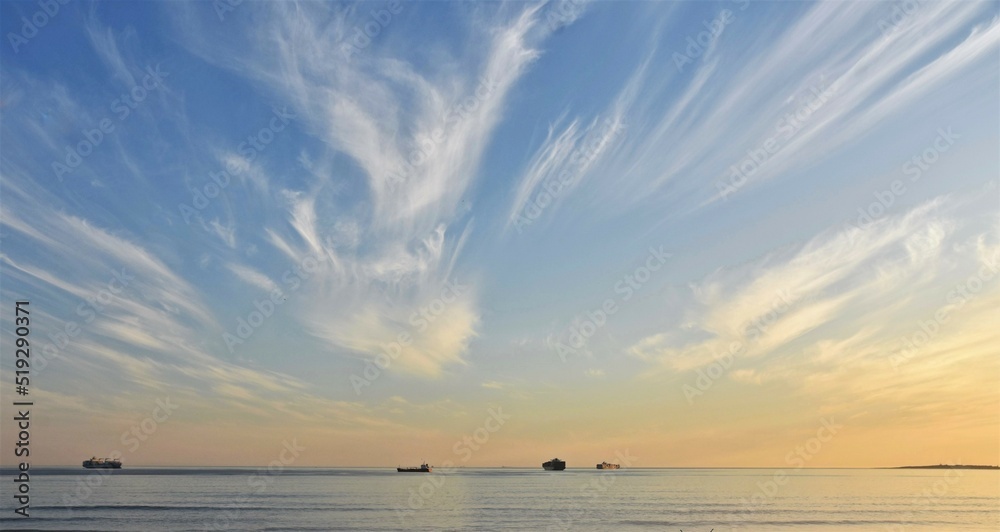 Obraz premium Landscape with a beautiful sunset and Container ships