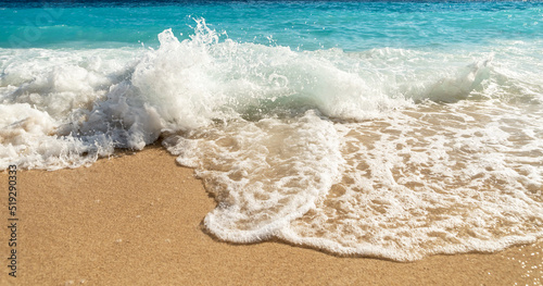 Close up photo of Kaputaş beach in Antalya with waves and bubbles.