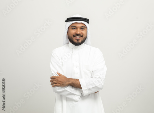 Portrait of arabic man with kandura dress on isolated white background. Arab business people photo