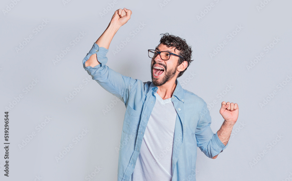 Handsome man raising his hand in victory isolated, Person celebrating and raising his hand in victory, Concept of person clenching and raising one hand in victory