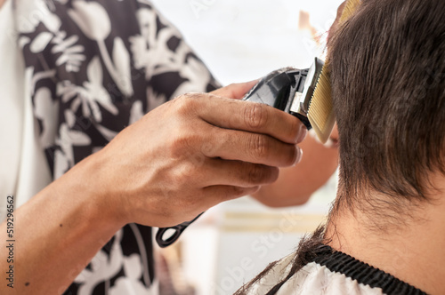 Man getting haircut with electric razor