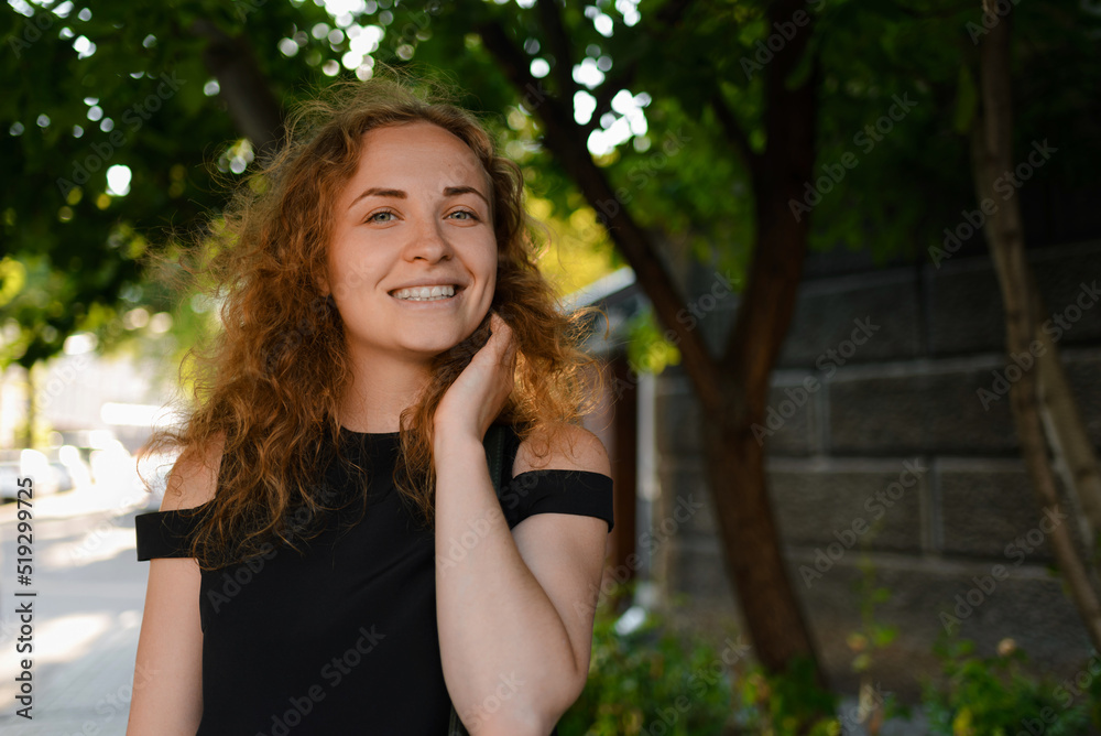 A young woman is smiling and looking at the camera A young woman is smiling and looking at the camera