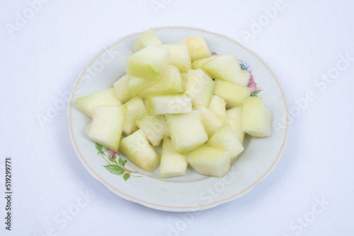 Honeydew melon. Whole fresh ripe sweet fruit with a sliced juicy piece of cut. 