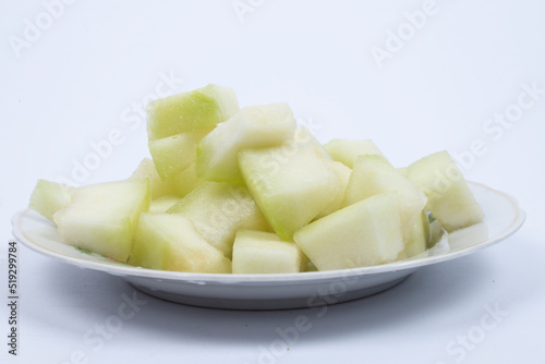 Honeydew melon. Whole fresh ripe sweet fruit with a sliced juicy piece of cut. 